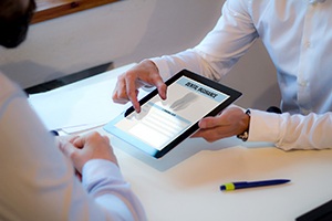 person looking at dental insurance information on a tablet