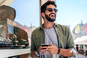 Man smiling while shopping outside