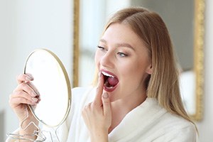South Portland patient touching dental implant