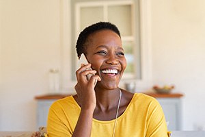 Woman smiling while talking on phone