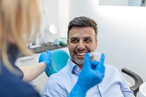 a man speaking with his dentist about Invisalign  