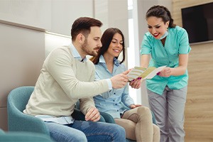 Dental professional explaining cost of cosmetic smile makeover