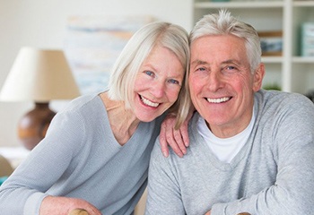 elderly couple smiling with dentures