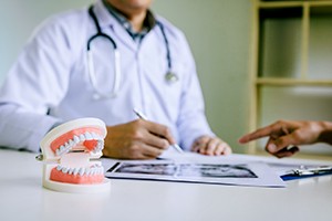 Dentist discussing cost of dentures in South Portland with patient