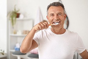 Man brushing teeth in South Portland