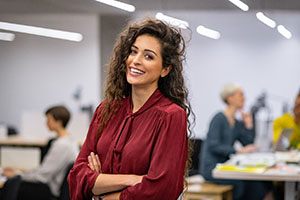 Woman in office smiling with dental implants in South Portland, ME