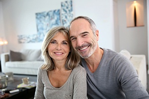 happy couple sitting on their couch