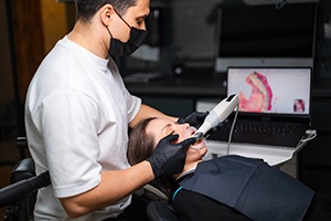 a dental professional taking a digital impression of a patient’s mouth