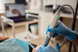 a person taking a digital impression of a patient’s mouth