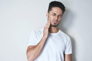 man in pain from lost dental crown