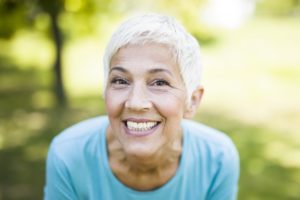 senior woman smiling proudly thanks to adult Invisalign in Portland 