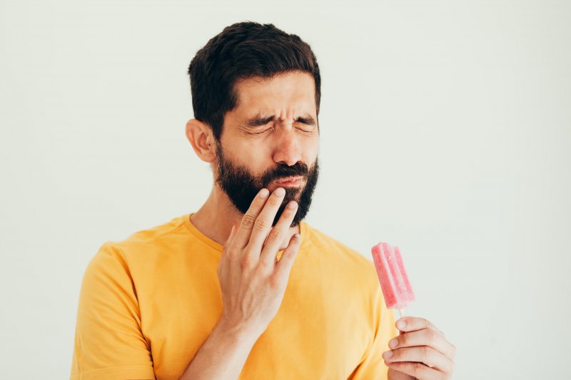 A man facing tooth sensitivity