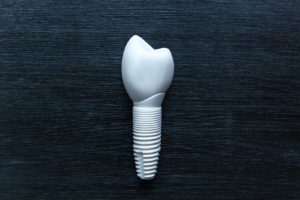 Zirconia dental implant on black background