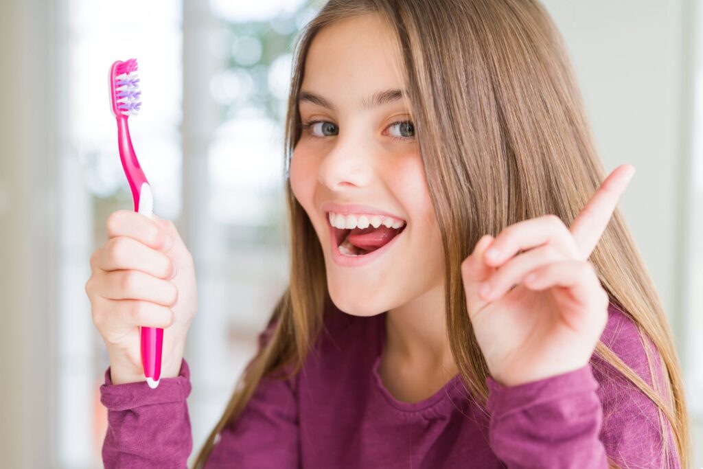 A woman holding a toothbrush